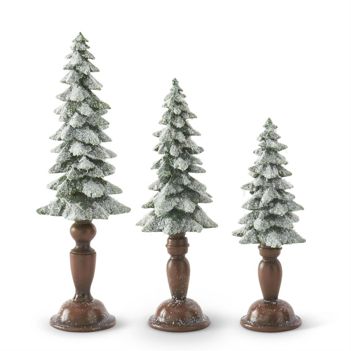 Three flocked and glittered resin Christmas trees on brown pedestal bases in small, medium, and large