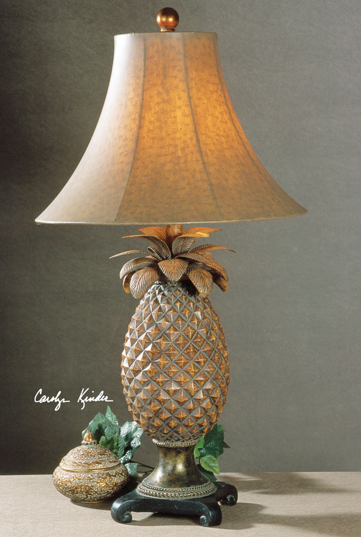 Anana table lamp with a natural woven rattan shade in earthy beige tones and a simple cylindrical silhouette.