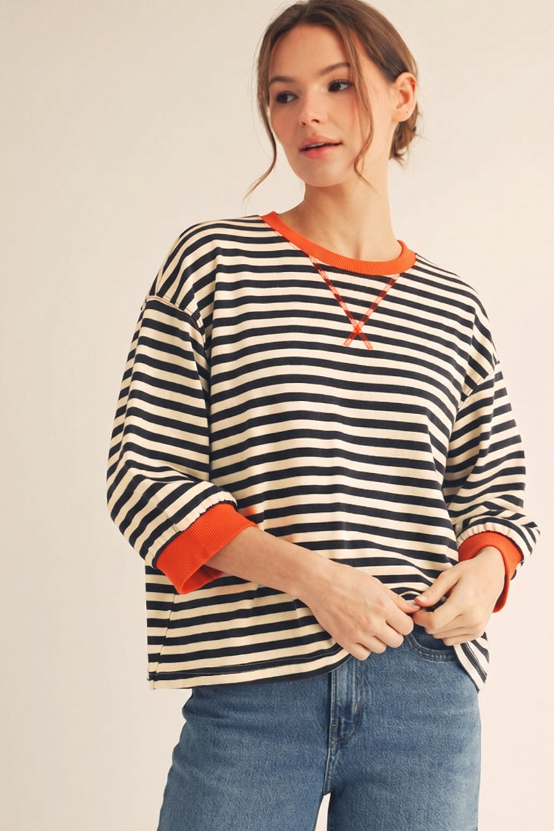 Woman wearing a Hannah V-notched Neck Stripe Casual Top with orange rib band contrast and 3/4 sleeves