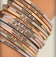 Gold-tone Embracelets bracelet featuring a textured chain link with an open heart-shaped clasp.
