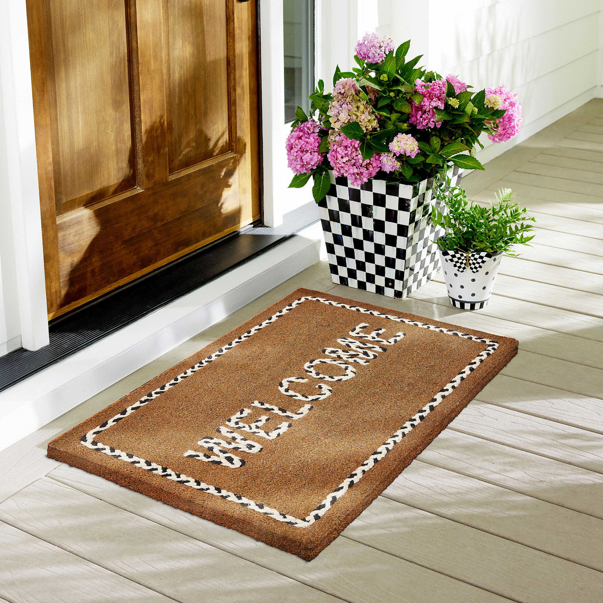 Braided coir entrance mat with inset welcome message