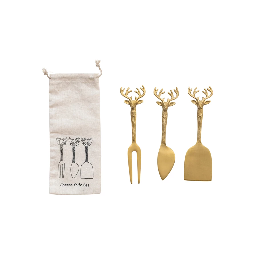 Brass cheese knife with festive reindeer handle in printed drawstring bag
