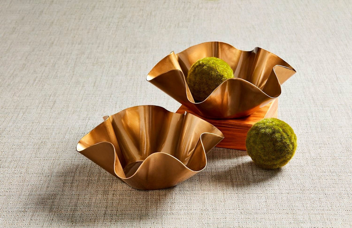 Nested cast aluminum bowls with shiny brass finish and ruffled edges.