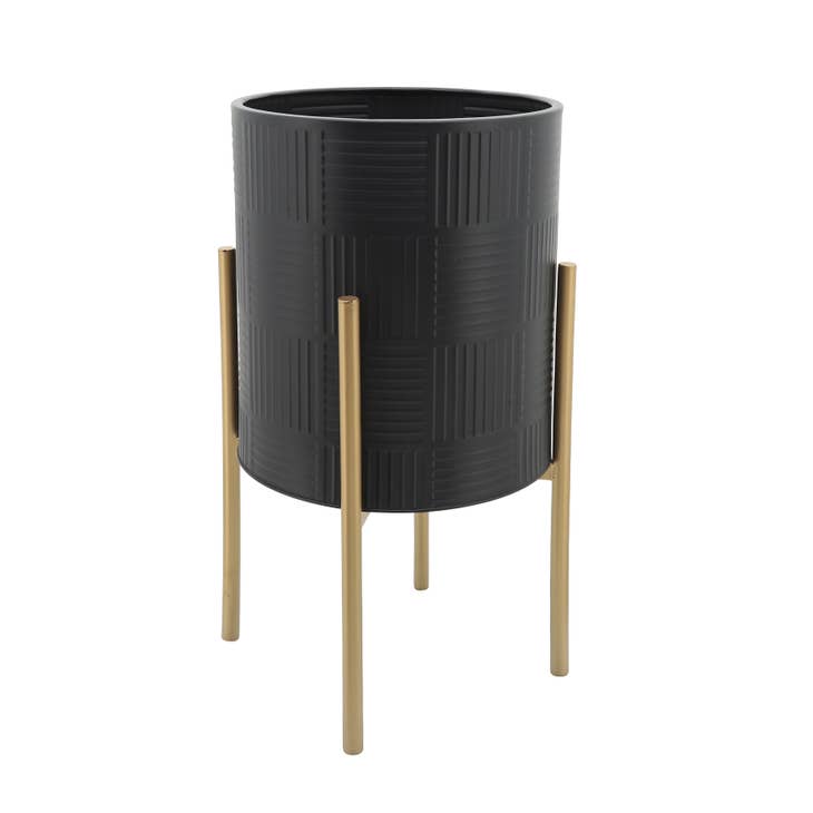 Black metal planter with gold lines on a stand