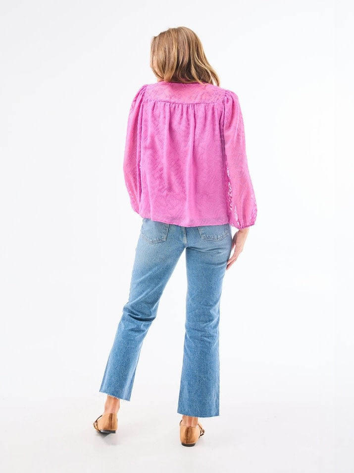 Back view of Brianna Top in Crocus featuring lined bodice, button-loop placket closure, and elastic cuffs on clip dot chiffon polyester.