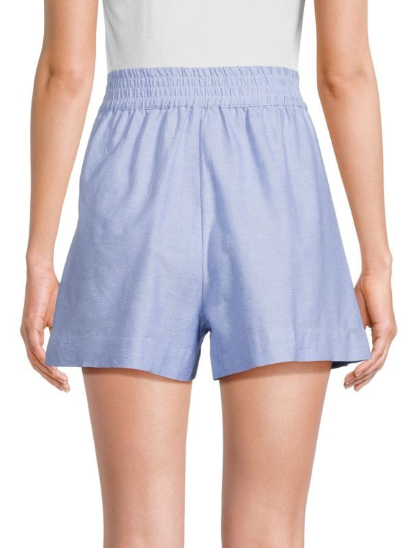Stella chambray shorts with elastic waistband and side slip pockets in light blue cotton.