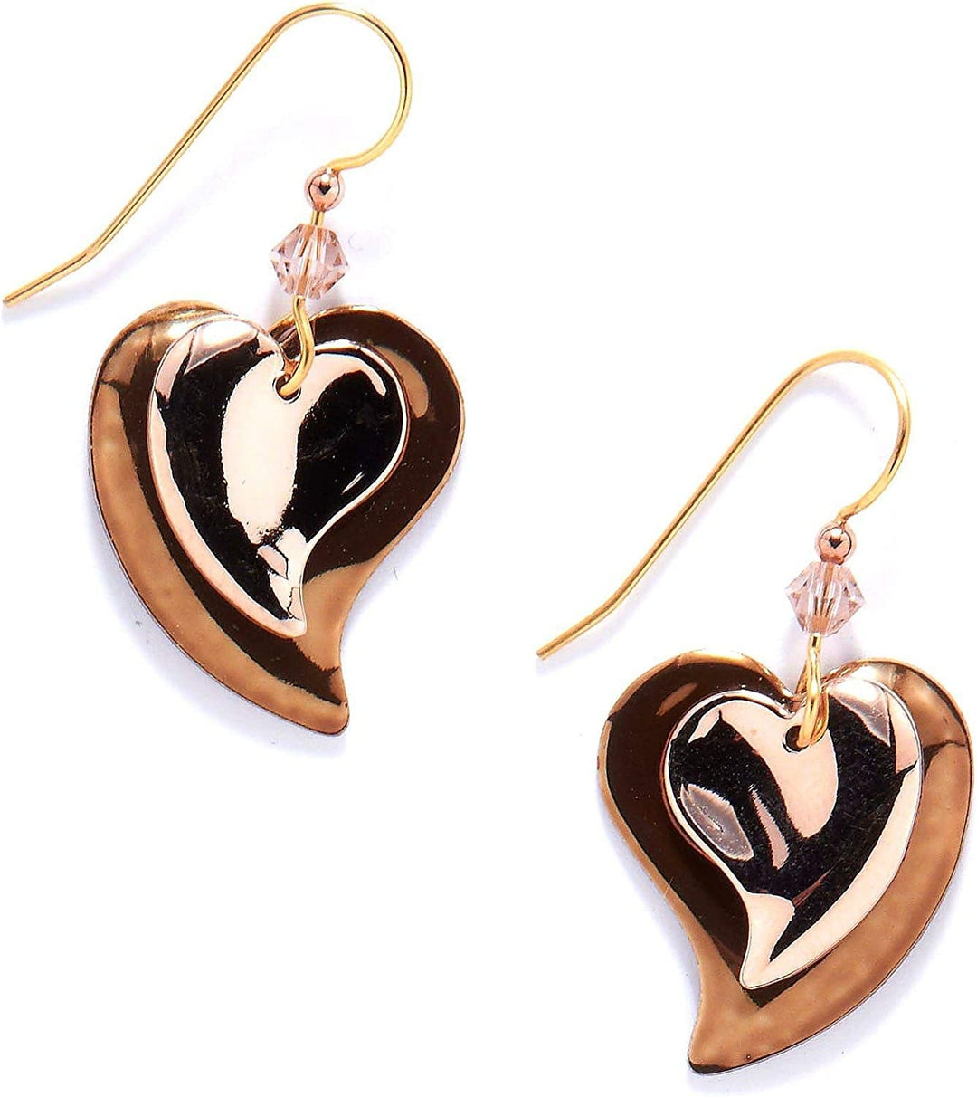 Bronze and copper heart-shaped earrings with textured metal surfaces.