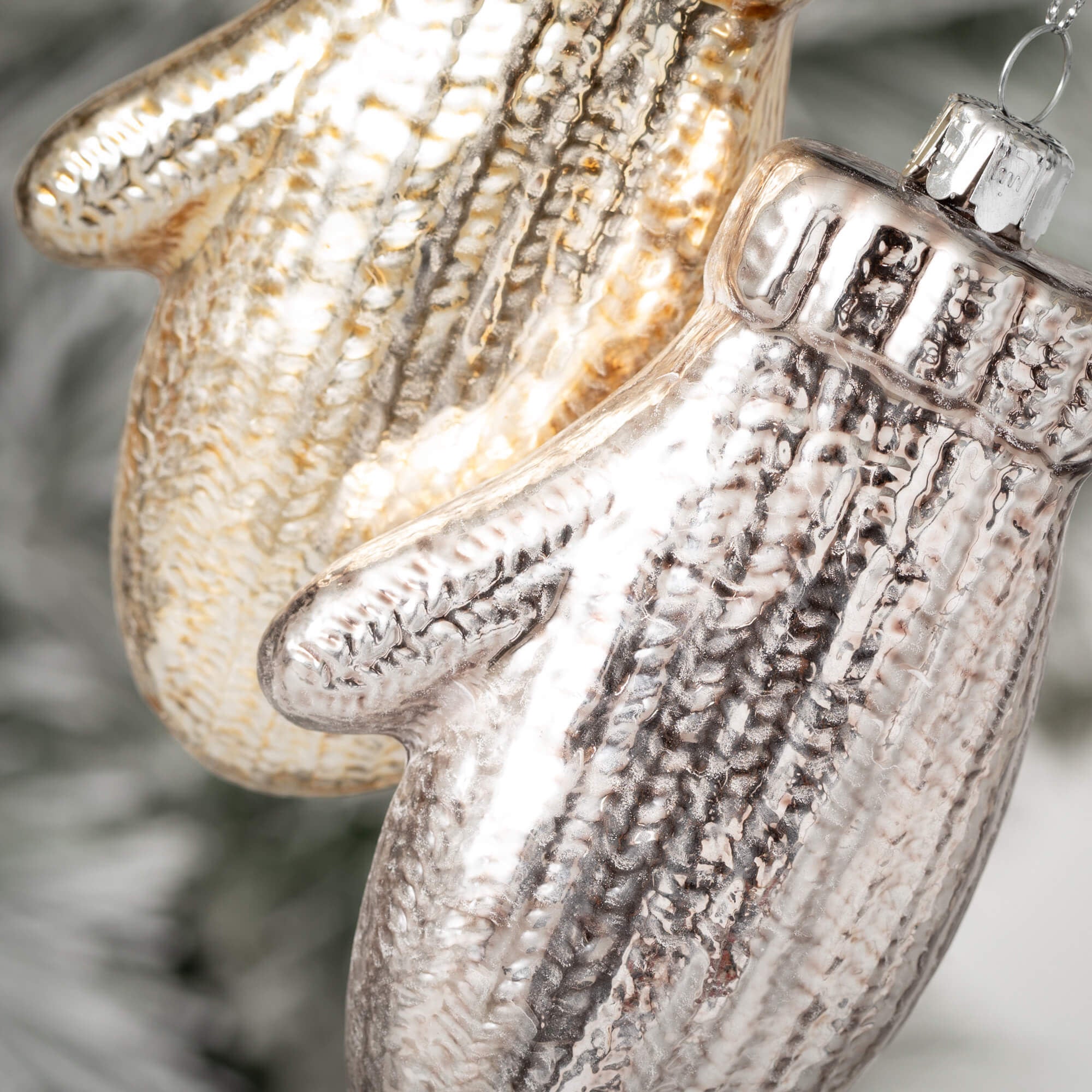 Glass brushed mitten ornament in warm neutral tone with textured finish.