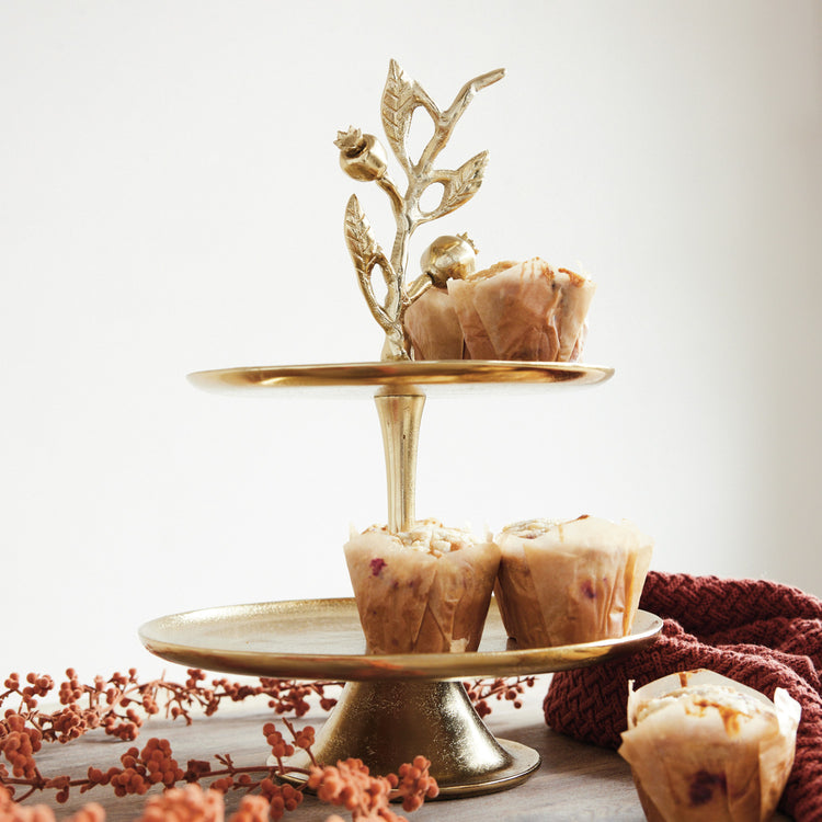 Gold cast aluminum 2-tier tray featuring a pomegranate branch shaped handle with muffins.