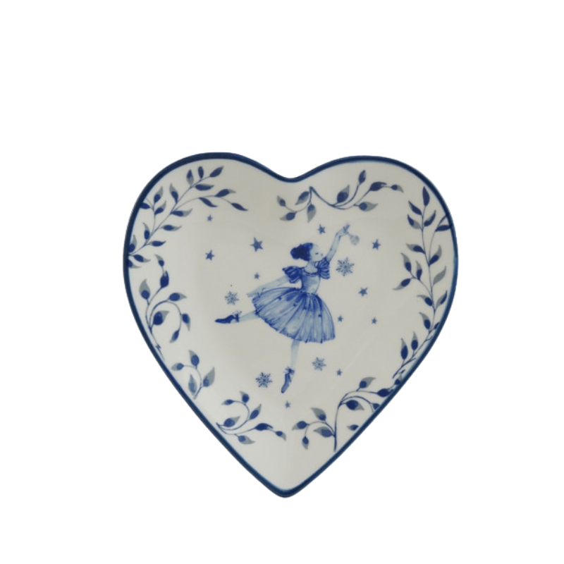 Heart-shaped white ceramic dish with blue glazed ballerina, snowflakes, and leaf patterns.