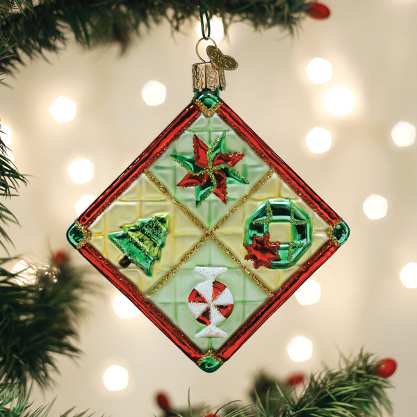 Diamond-shaped glass Christmas quilt ornament with a tree, wreath, candy, and star design.