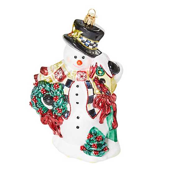 Glass snowman Christmas ornament with a white body, black top hat, red scarf, and smiling face.