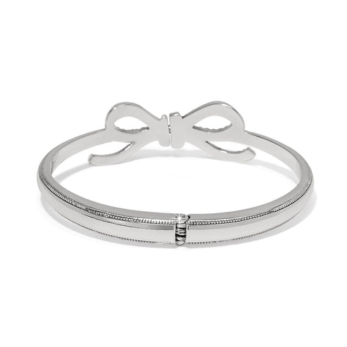 Silver plated Illumina Bow Hinged Bangle with crystal accents and a secure hinge closure.