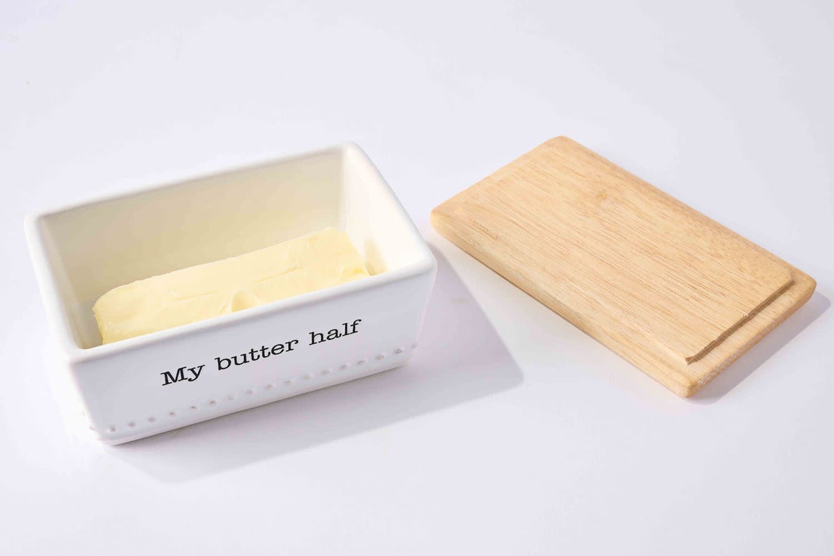 Debossed dolomite butter dish with wood lid holding a silverplate spreader