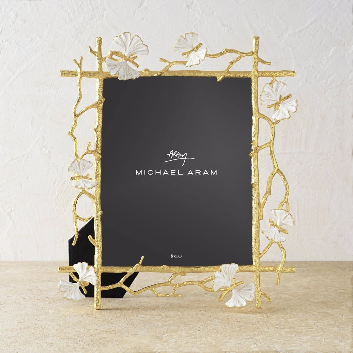 Goldtone brass butterfly-shaped frame with white enamel finish holding an 8x10 photo.