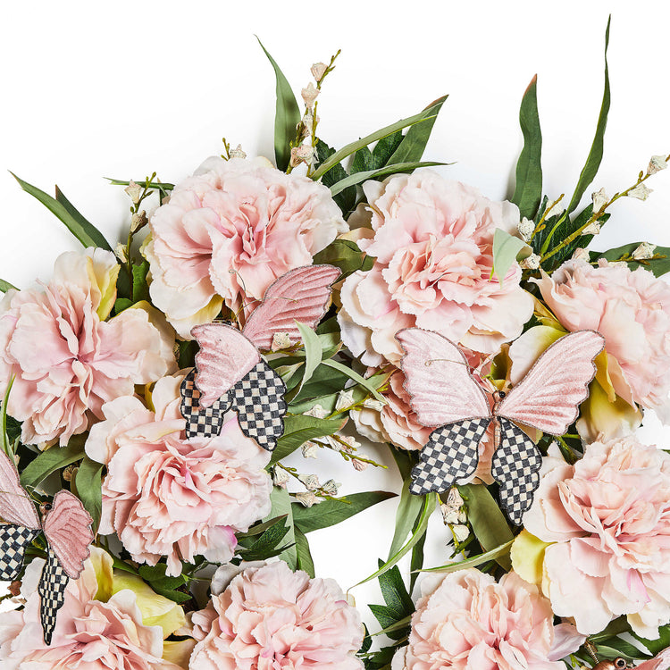 Pink peony wreath with butterfly accents on a natural base