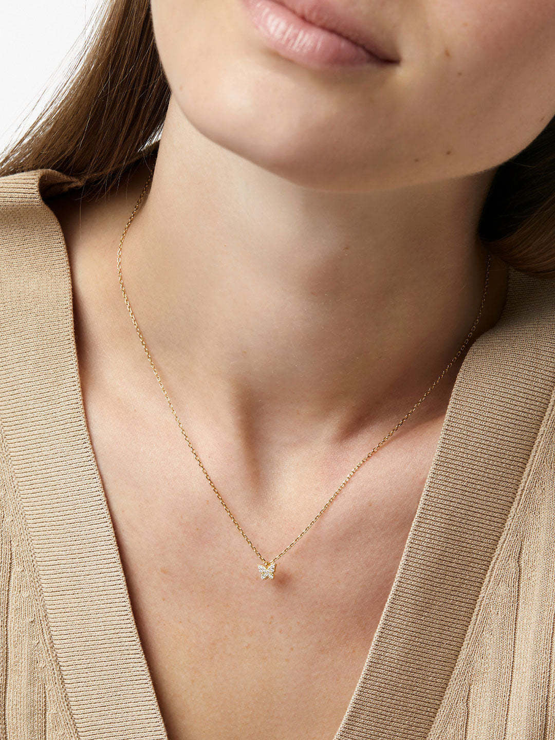Dainty recycled sterling silver butterfly necklace with cubic zirconia accents in gold dip finish.