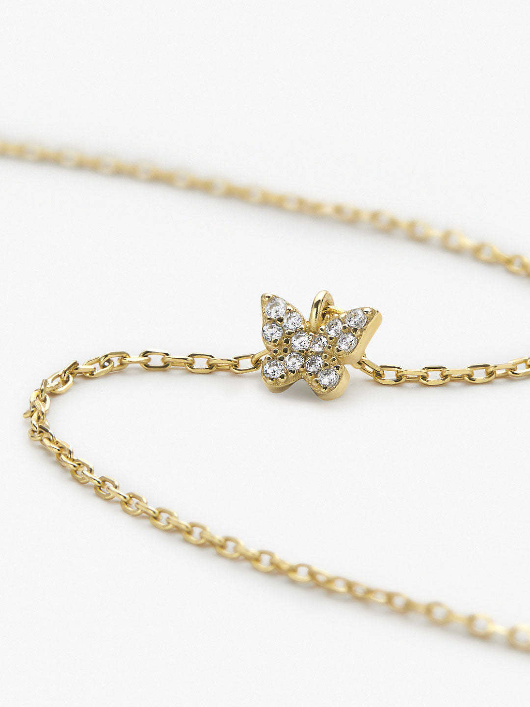 Dainty recycled sterling silver butterfly necklace with cubic zirconia accents on a gold-dipped chain.