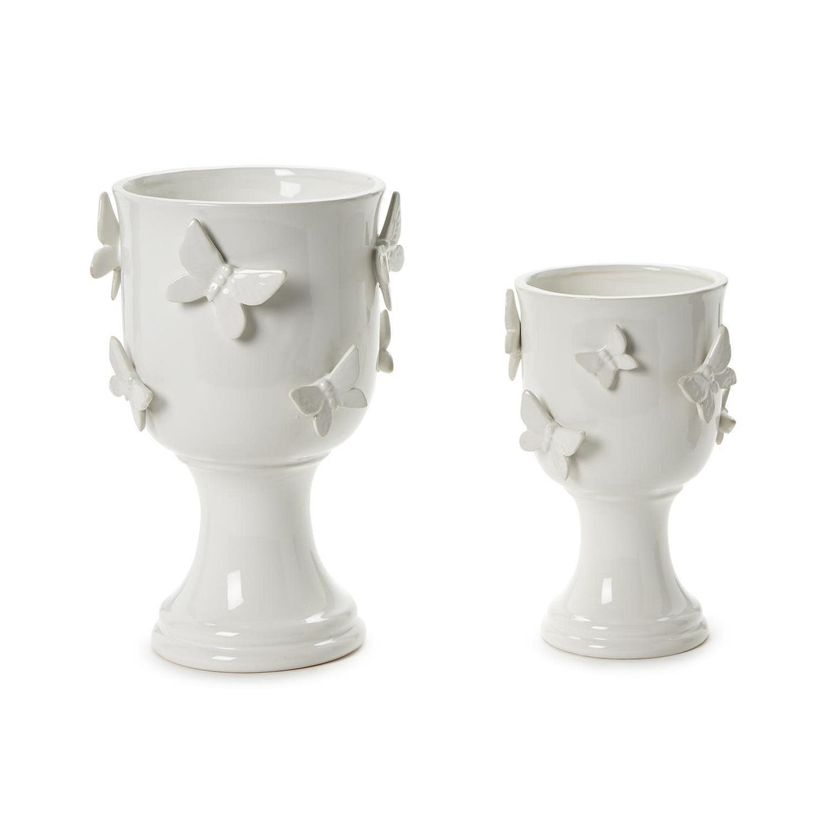Ceramic pedestal cachepot with sculpted butterfly wings in natural earth tones.