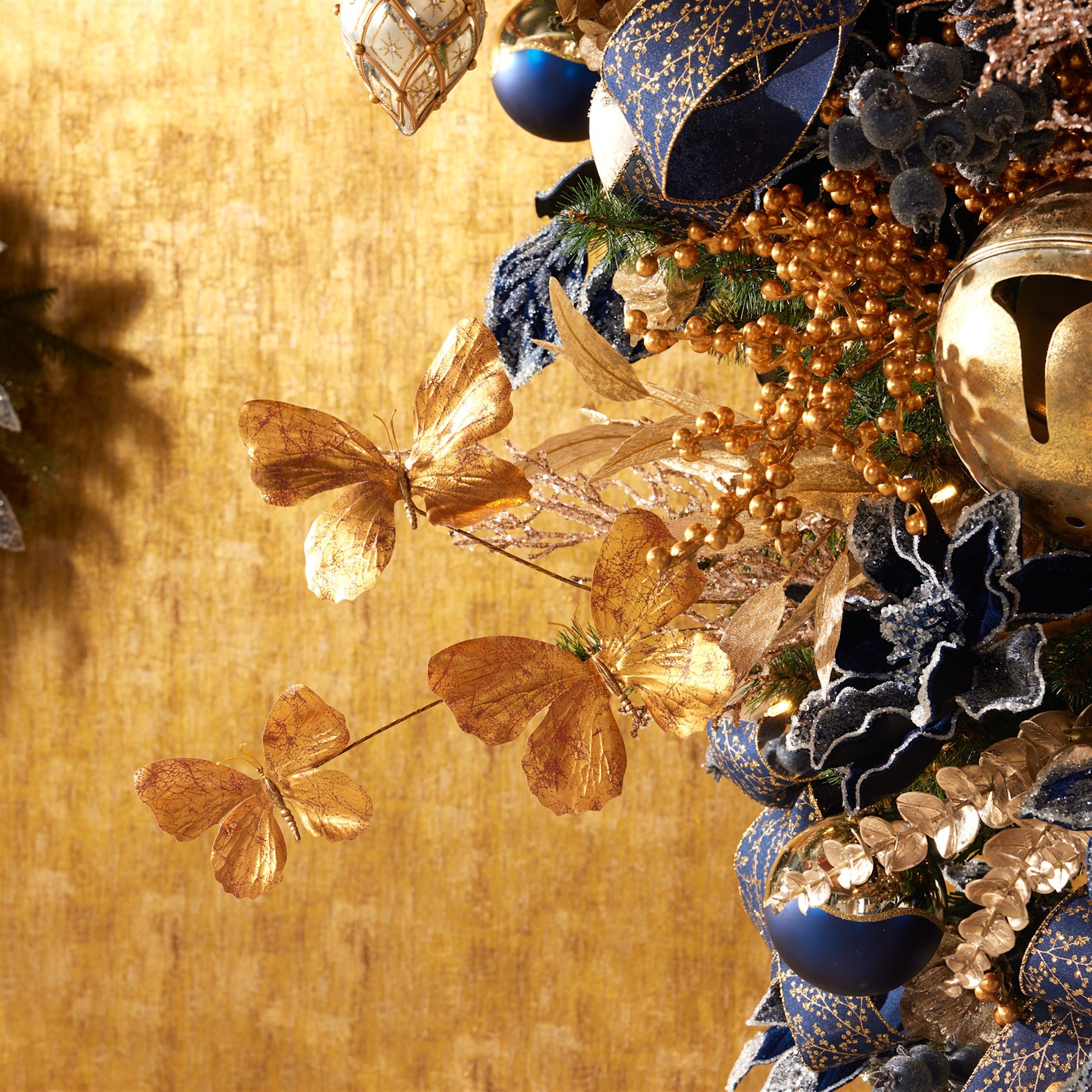 Polyester butterfly spray with three lustrous textured butterflies on a 27-inch stand.