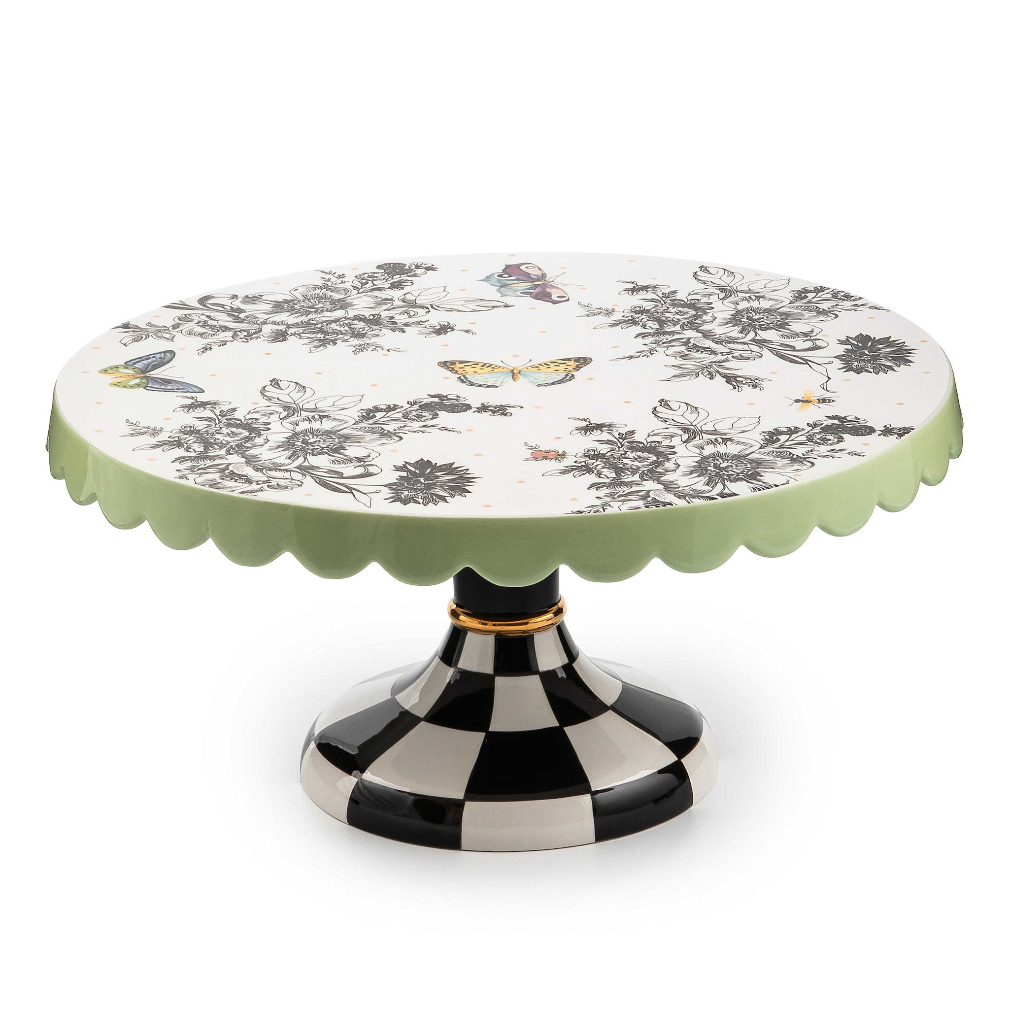 Large ceramic pedestal platter with butterfly toile pattern on checked base and pistachio scalloped edges.