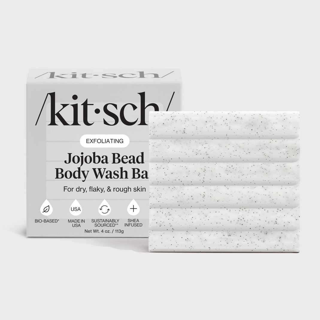 Jojoba Bead Exfoliating Body Wash Bar in a white rectangular container with green accents.