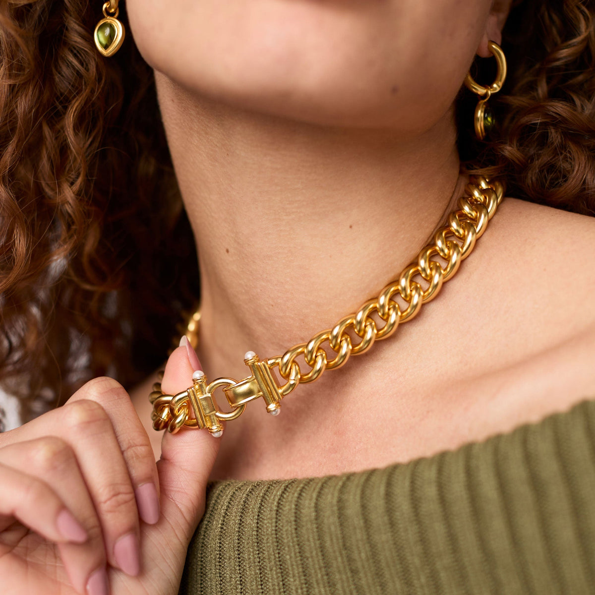 Close-up of a person wearing a 24K gold plated Dolce Link Necklace with a pearl fold over clasp.