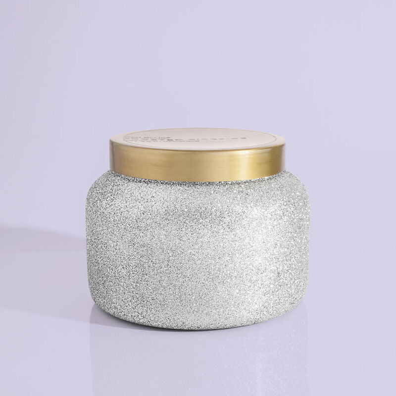 Glam Frosted Fireside jumbo jar candle in frosted glass with a warm amber flame visible inside.