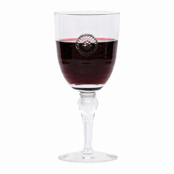 Berry & Thread Wine Glass filled with red wine, featuring a clear glass stem and medallion detail.
