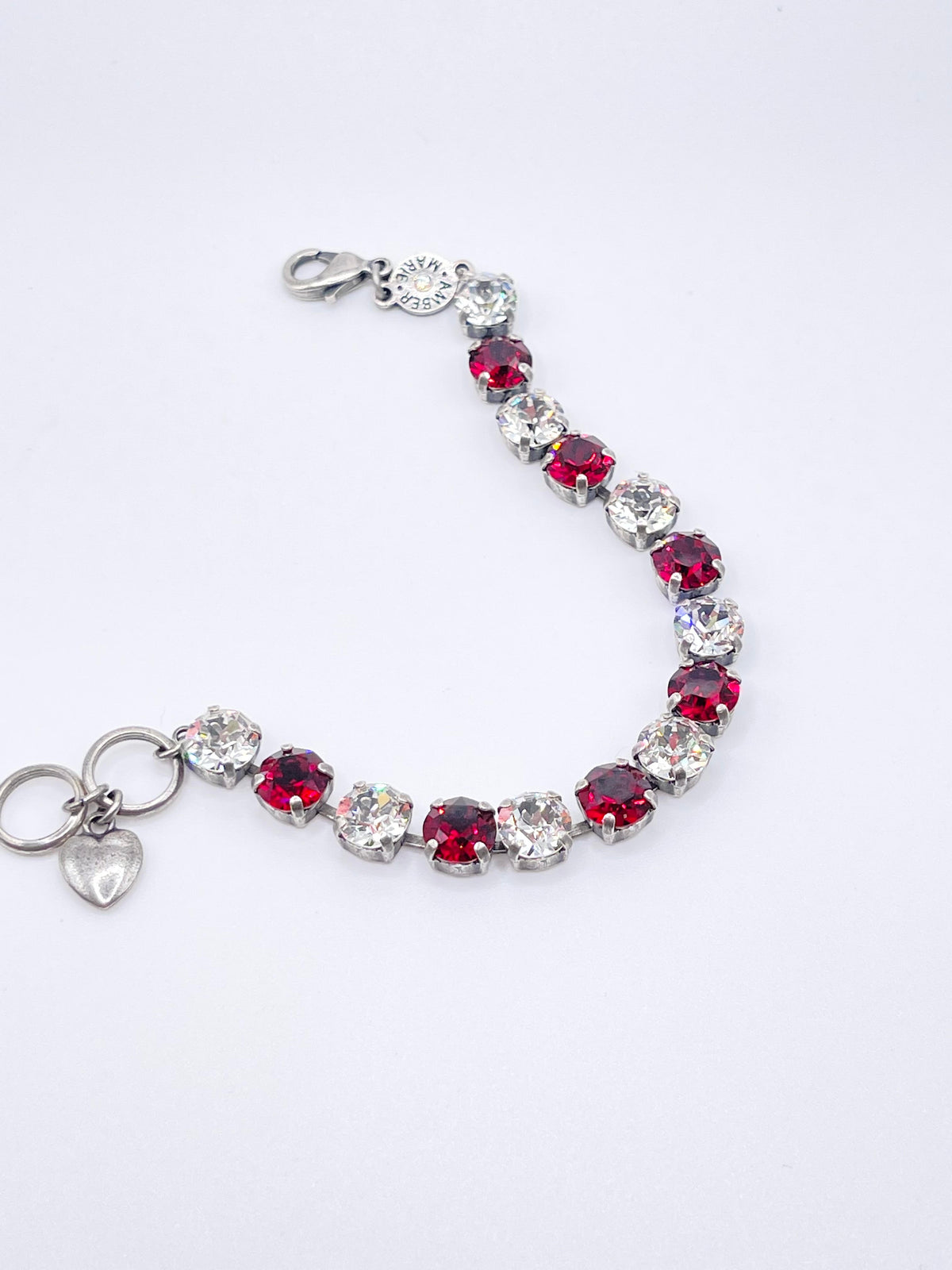Classic Rome bracelet featuring deep red stones with black accents on a clear band.