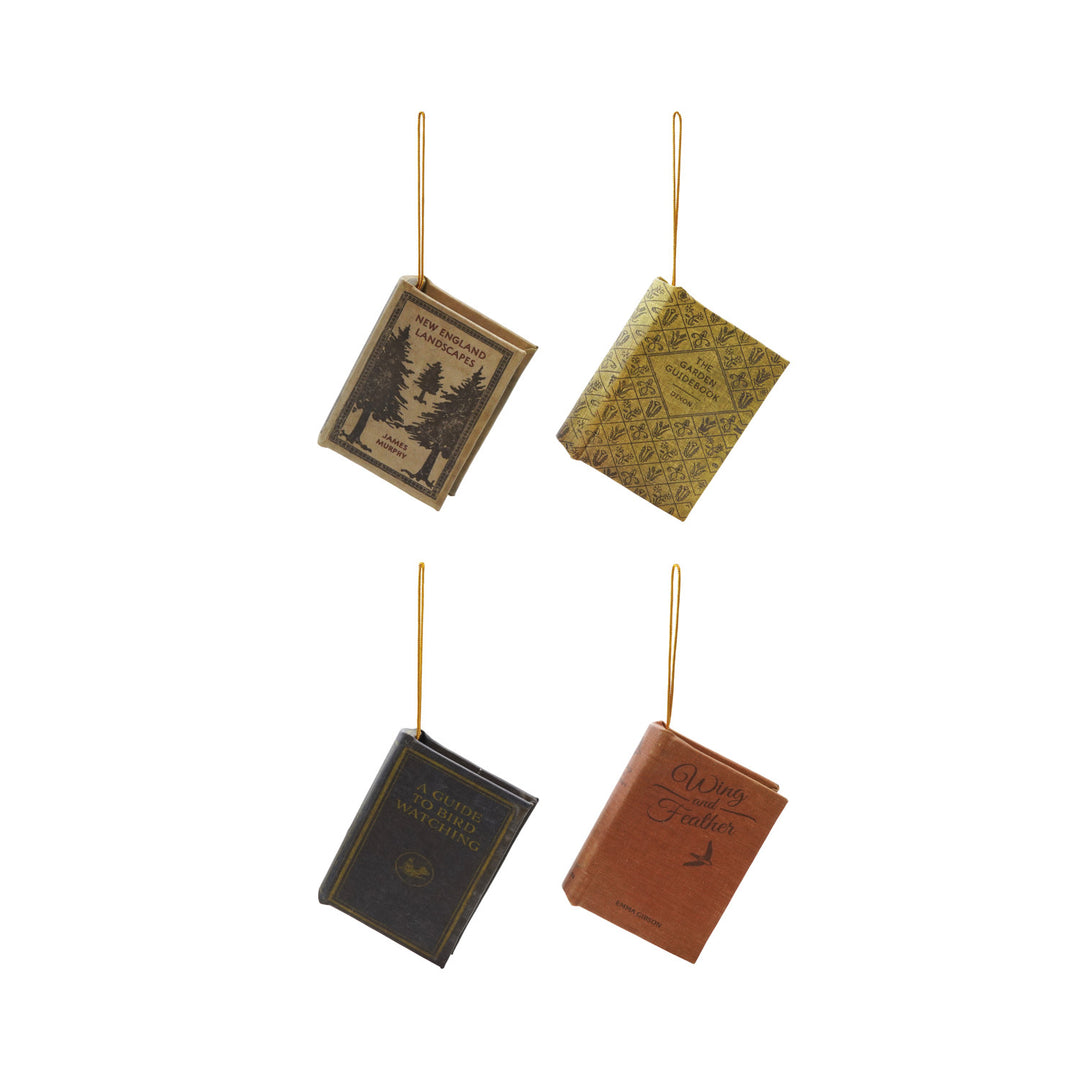 Four assorted vintage-style book ornaments with titles like Wing and Feather and Bird Watching.