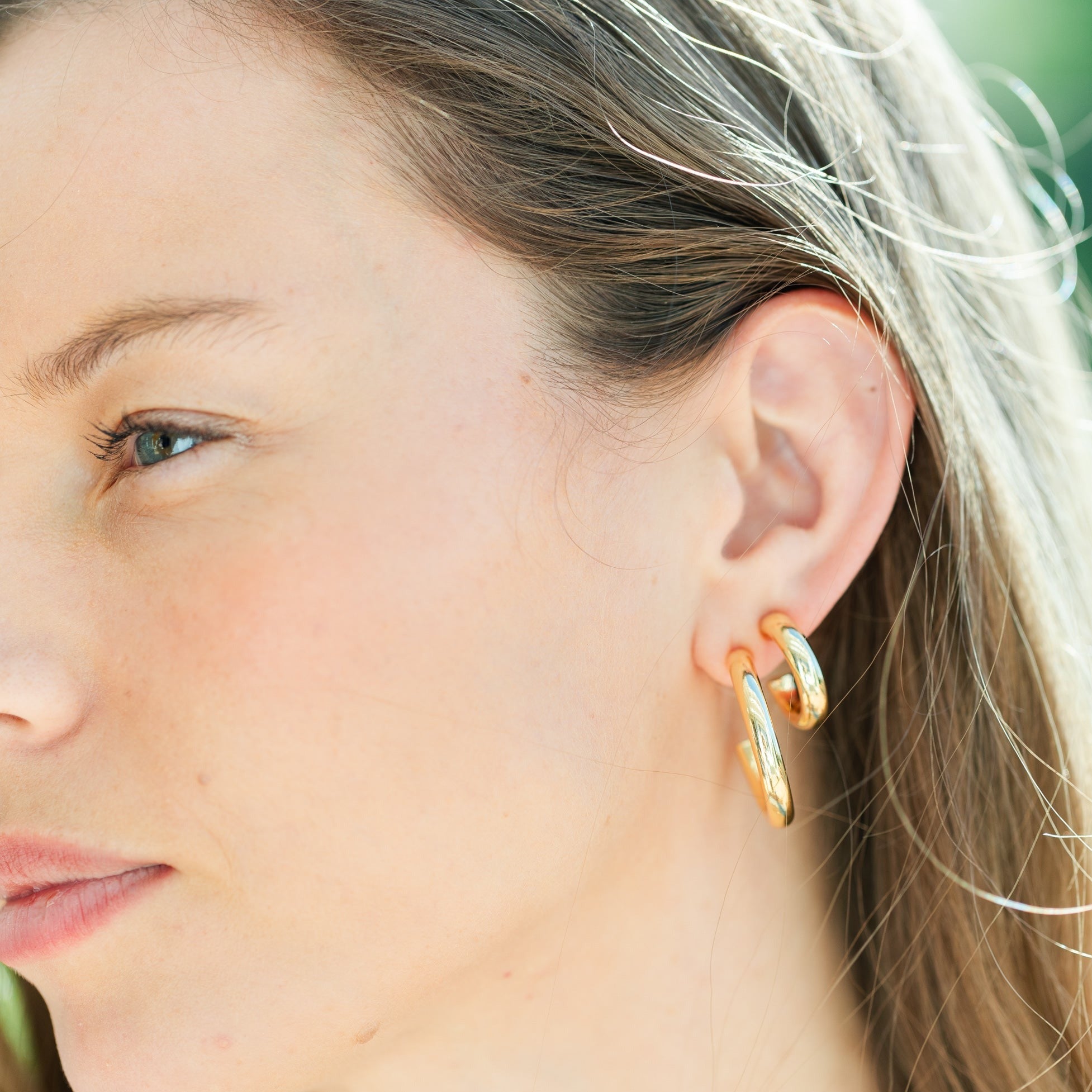 Brass hoop earrings with a smooth circular silhouette