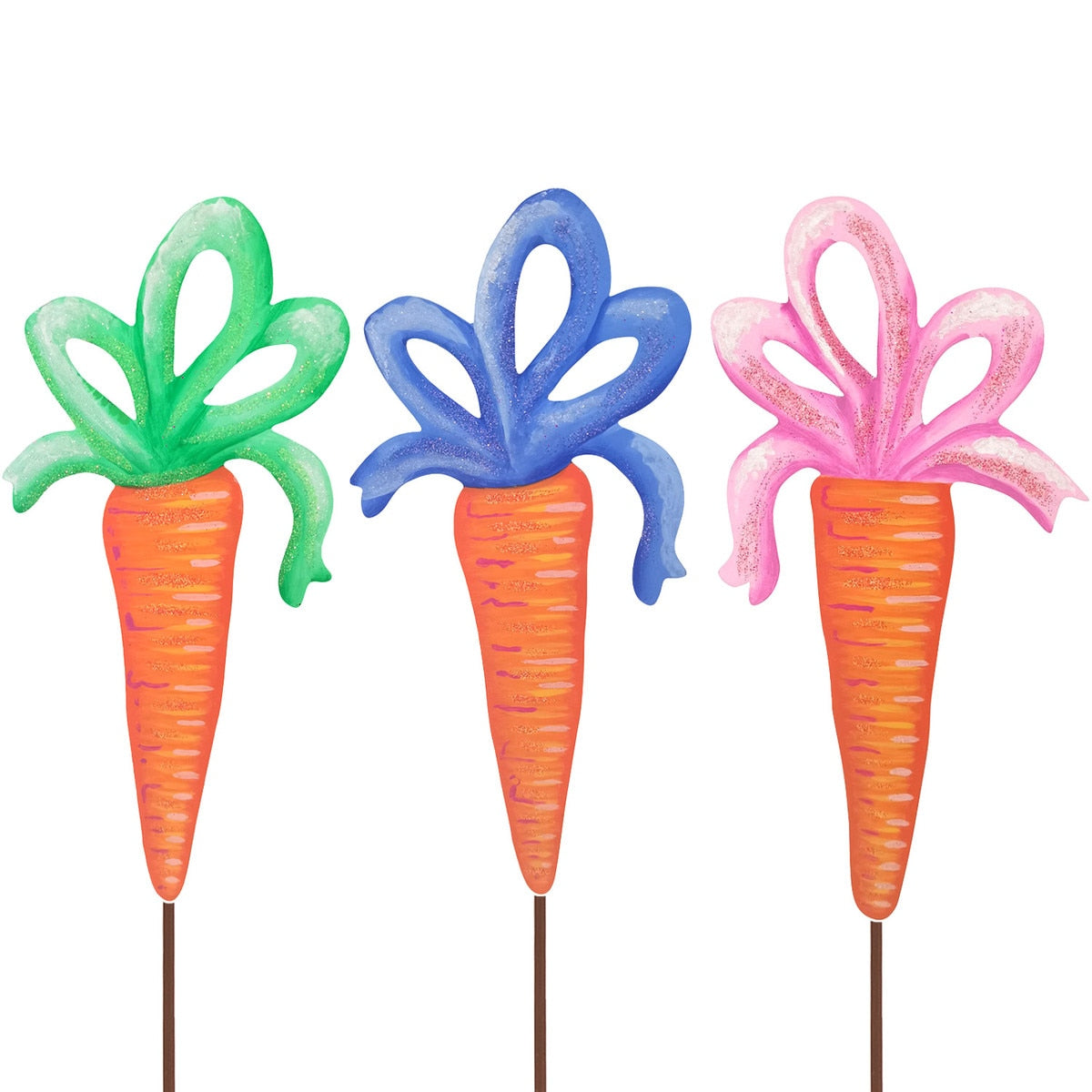 Three decorative carrots with green, blue, and pink ribbon tops, each on a stake.