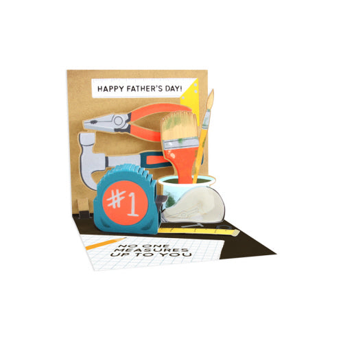 White envelope with matte gold foil text reading Happy Father's Day inside.
