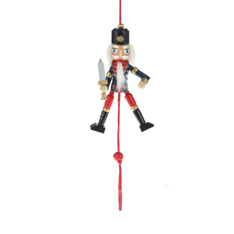 5-inch wooden nutcracker pull puppet ornament with movable limbs and a sword, hanging on a red cord.