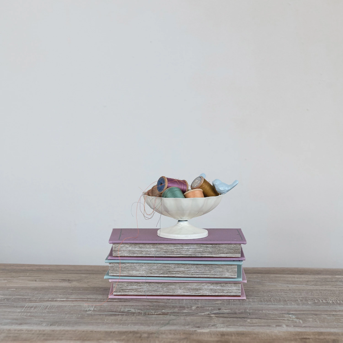 Decorative metal scalloped bowl with three-dimensional cast iron birds perched on the rim.