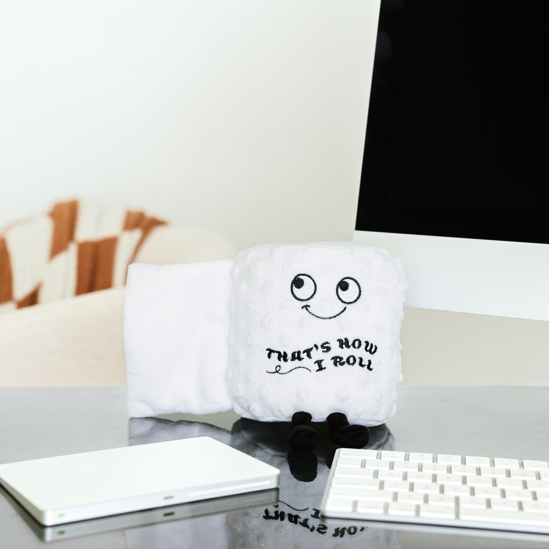 Plush toilet paper roll with a soft texture in neutral tones.