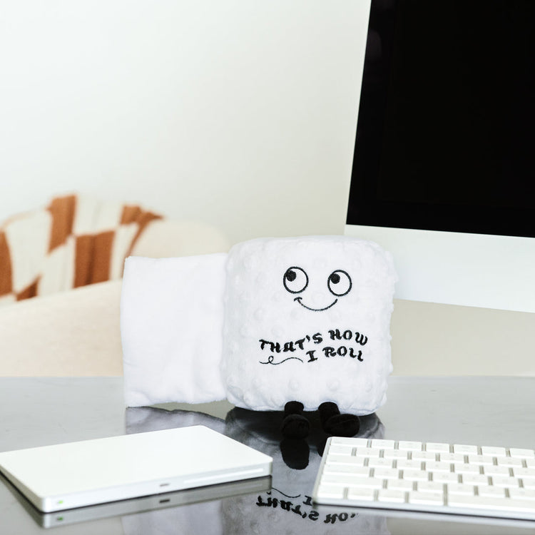 Plush toilet paper roll with a soft texture in neutral tones.