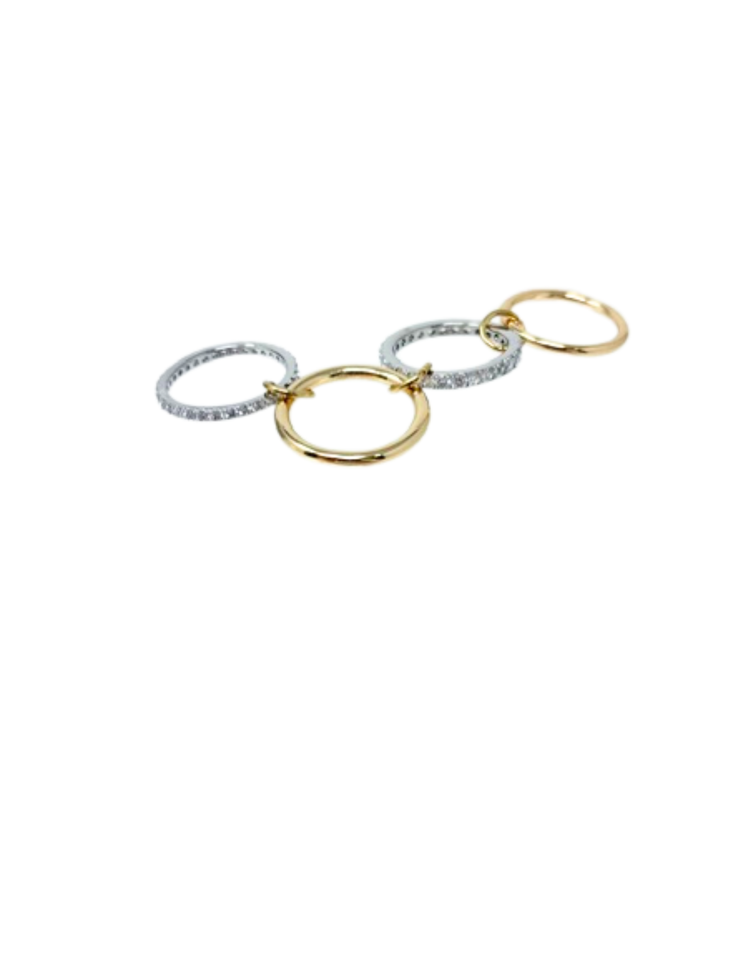 Four interlocking fashion rings in alternating silver with pavé stones and smooth gold finishes.