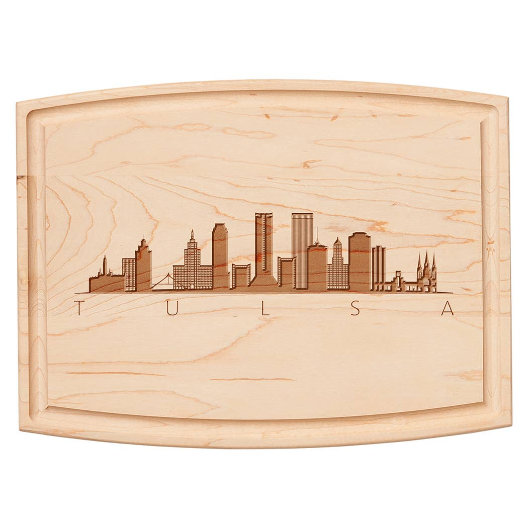 Arched artisan maple cutting board with an engraved Tulsa skyline and the word TULSA.