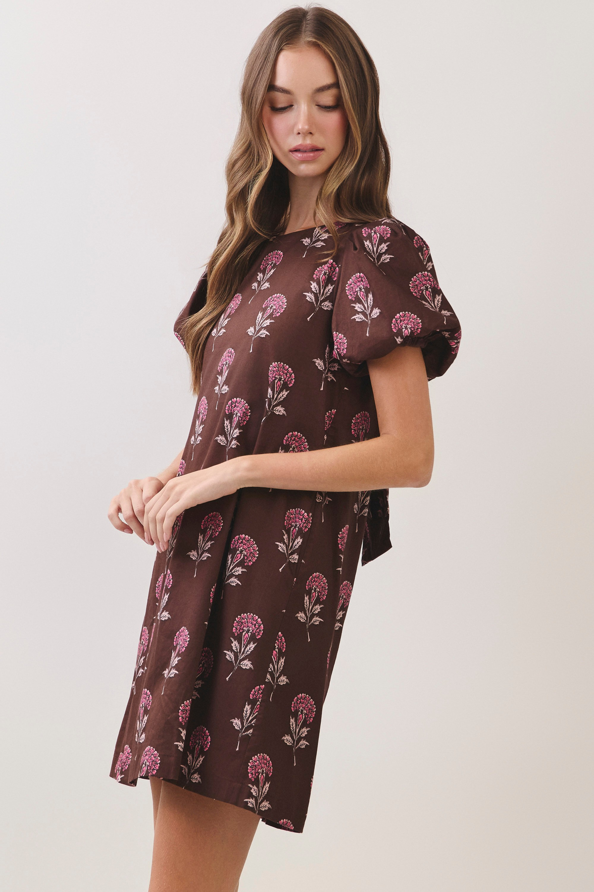Brown floral print mini dress with short puff sleeves and a relaxed A-line silhouette.