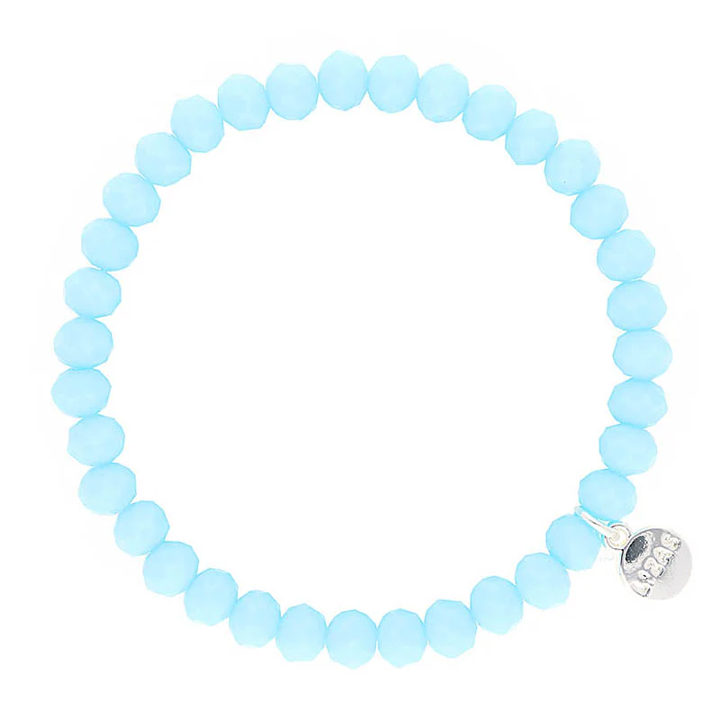 Lizas light blue crystal bead stretch bracelet with a silver logo charm.