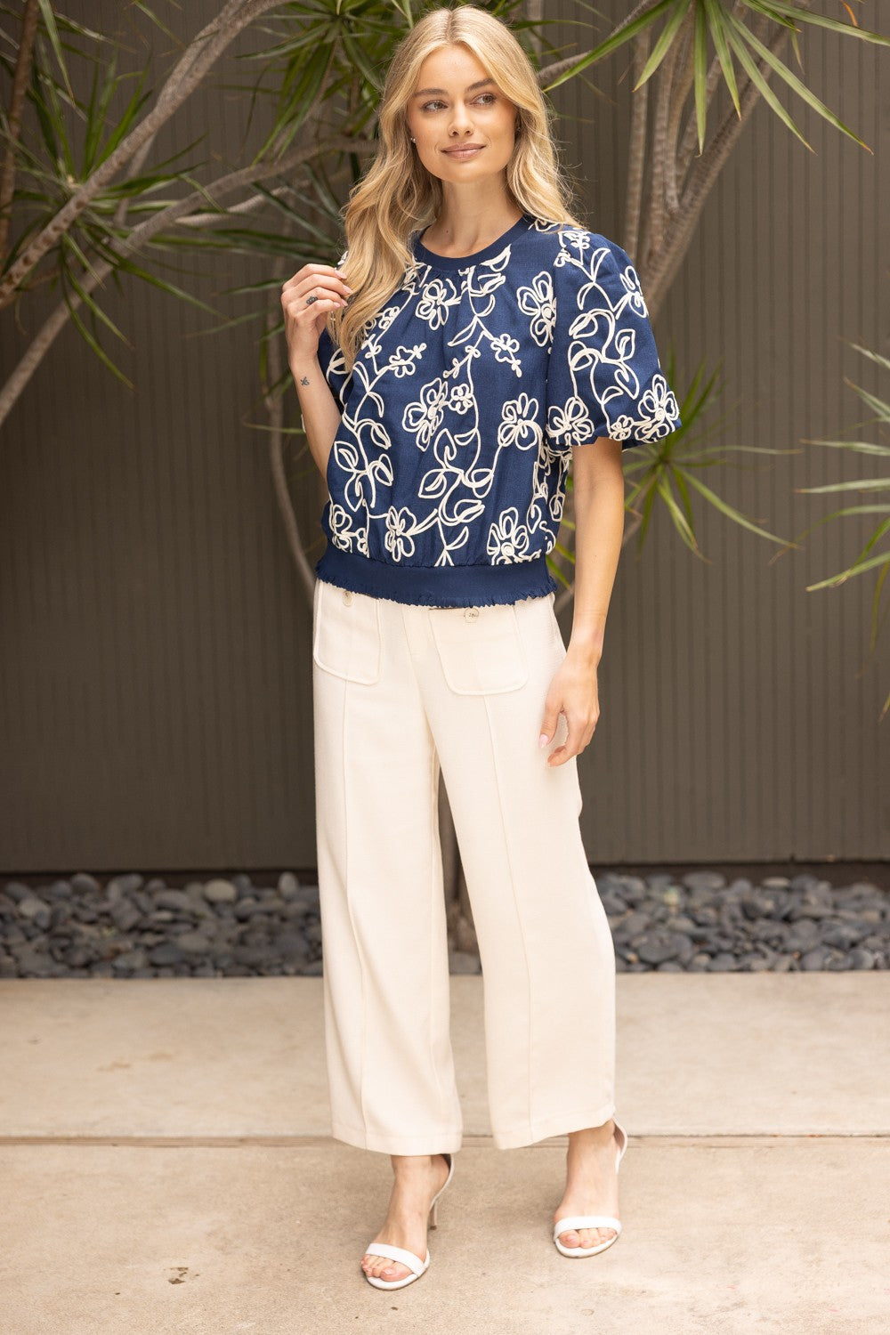 Natty floral embroidered short bubble sleeve top with round neckline and ruffled hem in woven fabric