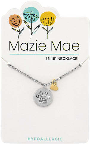 Silver Mazie Mae necklace with a crystal-studded paw print disc and a small gold heart charm.