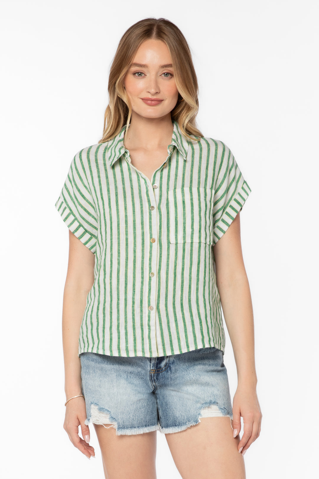 Woman wearing the Kirsty Stripe Top, a green and white vertical striped linen-blend button-up.