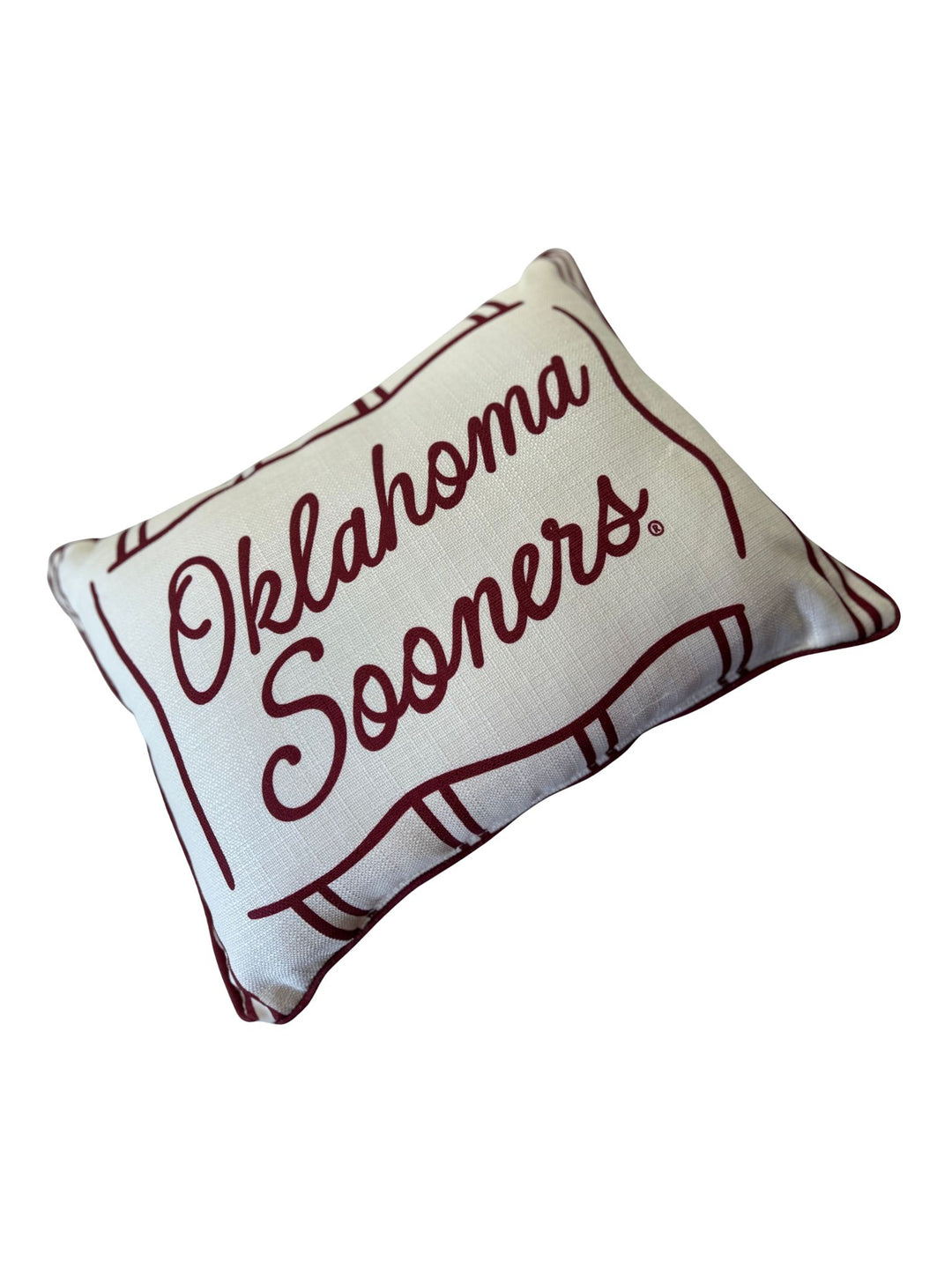 White rectangular pillow with crimson piping and Oklahoma Sooners text in script.