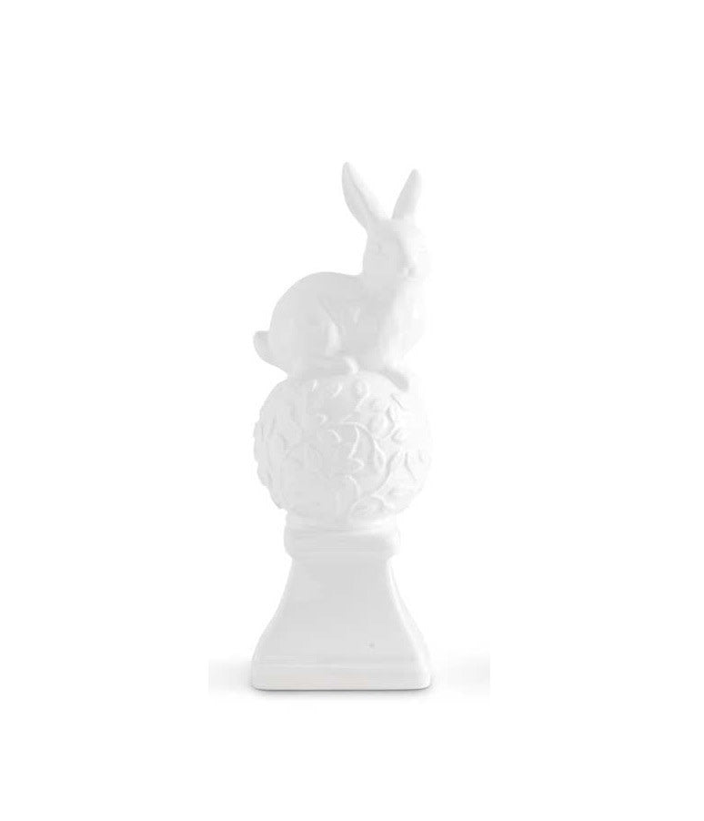 White ceramic finial shaped like two bunnies sitting on top.