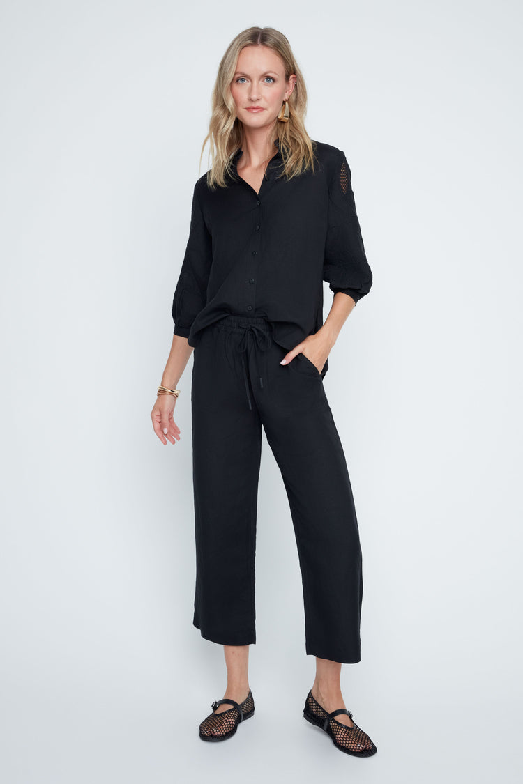 Relaxed-fit Victoria woven pants in neutral tone with elastic waistband, drawstring, and side pockets.