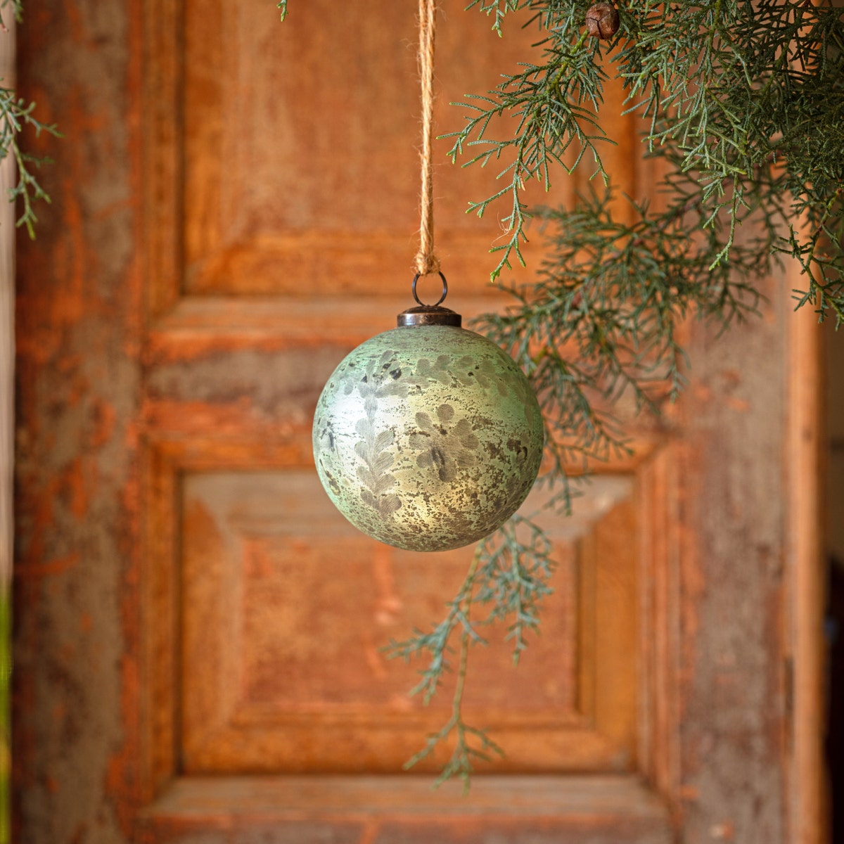4-inch spruce green antique foil glass ball ornament with etched floral patterns.