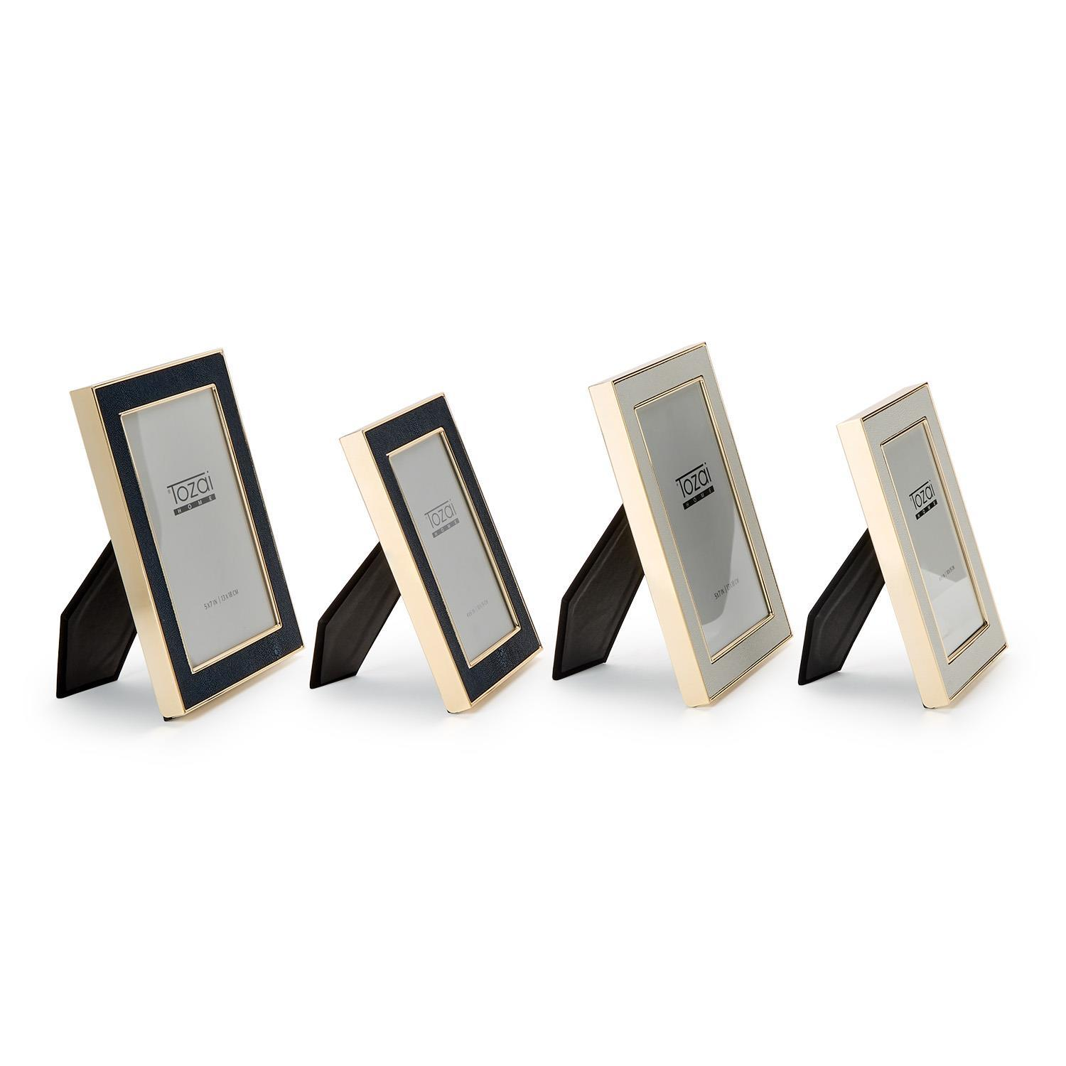 Four Astor Shagreen Photo Frames in navy and cream with gold trim, shown in two sizes.